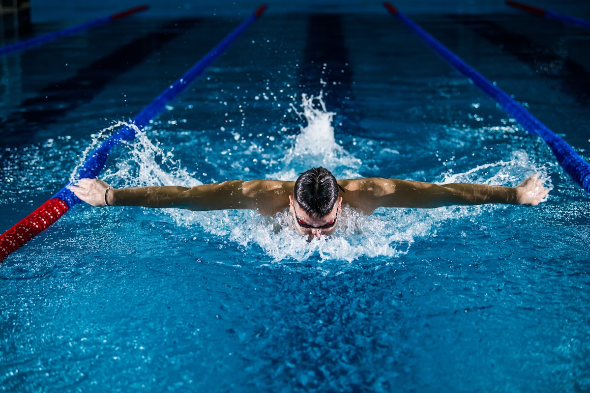 Swimmer practising breaststroke in a Malaysian public swimming pool